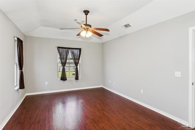 unfurnished room featuring ceiling fan, baseboards, dark wood-style floors, and visible vents