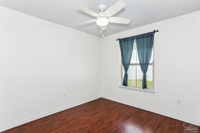 spare room featuring wood finished floors, baseboards, and a ceiling fan