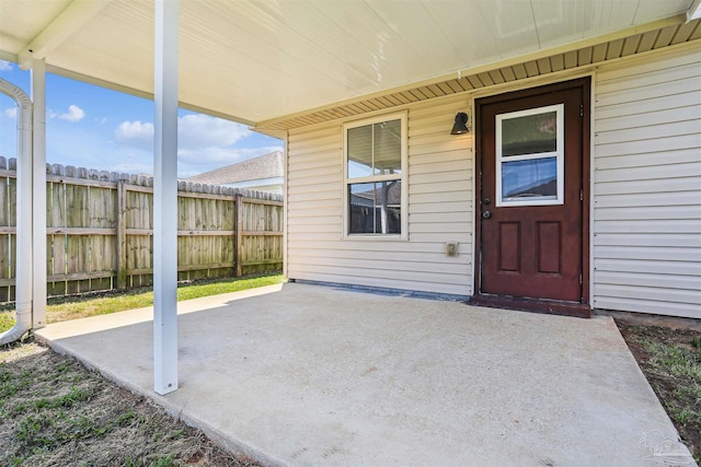 property entrance featuring a patio and fence