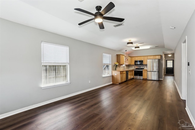 kitchen with light countertops, a wealth of natural light, lofted ceiling, and stainless steel appliances