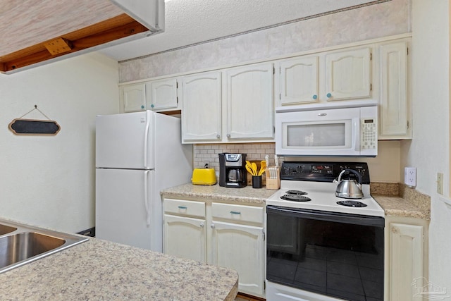 kitchen with a sink, white appliances, backsplash, and light countertops