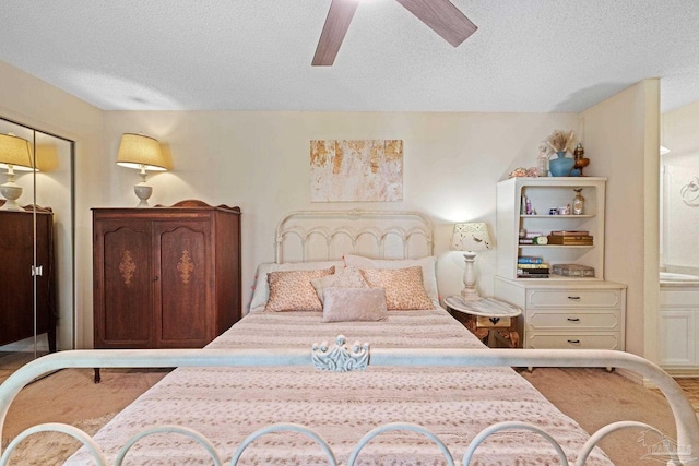 bedroom featuring a textured ceiling and a ceiling fan