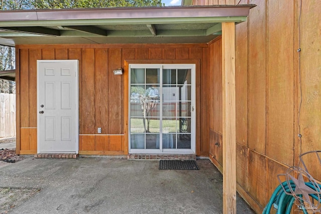 view of exterior entry featuring a patio area