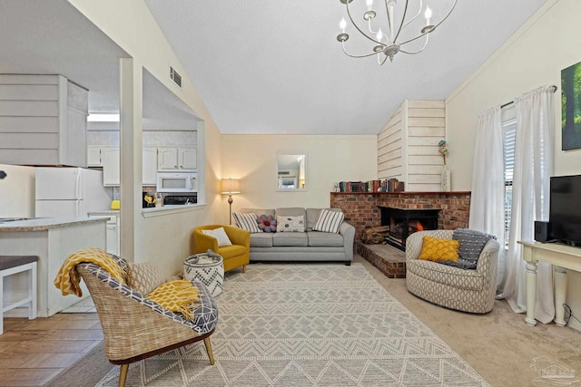 living area with visible vents, a brick fireplace, a chandelier, and vaulted ceiling