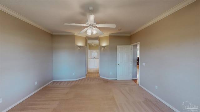 carpeted spare room with ceiling fan and ornamental molding