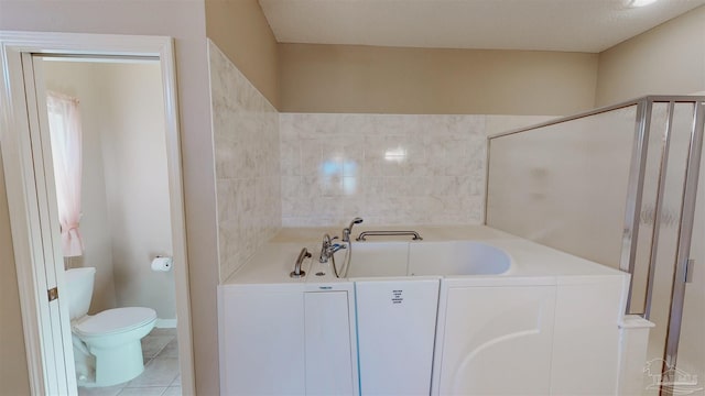 bathroom with tile patterned flooring, shower with separate bathtub, and toilet