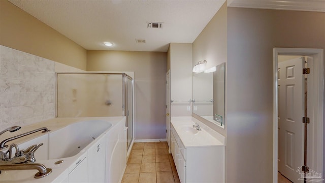 bathroom with tile patterned flooring, vanity, shower with separate bathtub, and a textured ceiling