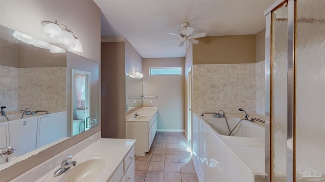 bathroom with vanity, a tub, ceiling fan, washer / clothes dryer, and tile patterned flooring