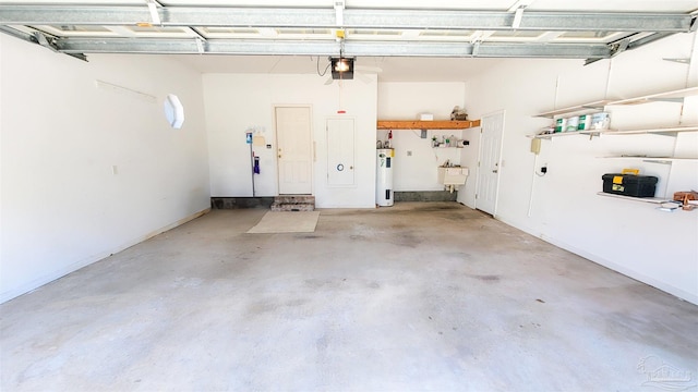 garage with a garage door opener, electric water heater, and sink