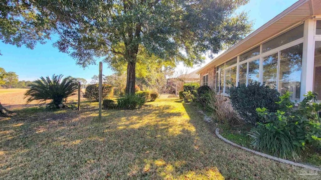 view of yard featuring a sunroom