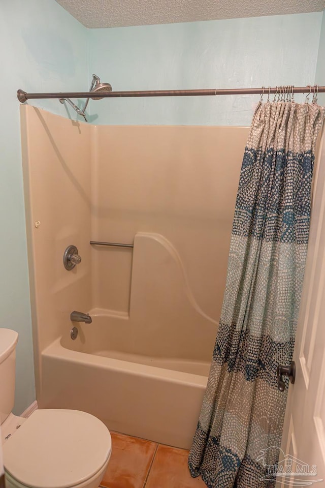 10129 Huntsman Path, Pensacola, FL 32514 - bathroom featuring tile patterned flooring, toilet, a textured ceiling, and shower / bath combination with curtain