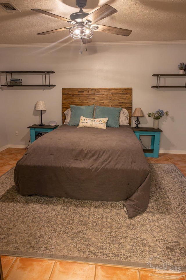 10129 Huntsman Path, Pensacola, FL 32514 - bedroom featuring crown molding, a textured ceiling, a ceiling fan, baseboards, and visible vents