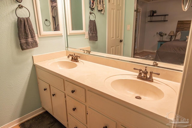 10129 Huntsman Path, Pensacola, FL 32514 - bathroom with connected bathroom, double vanity, a textured wall, and a sink