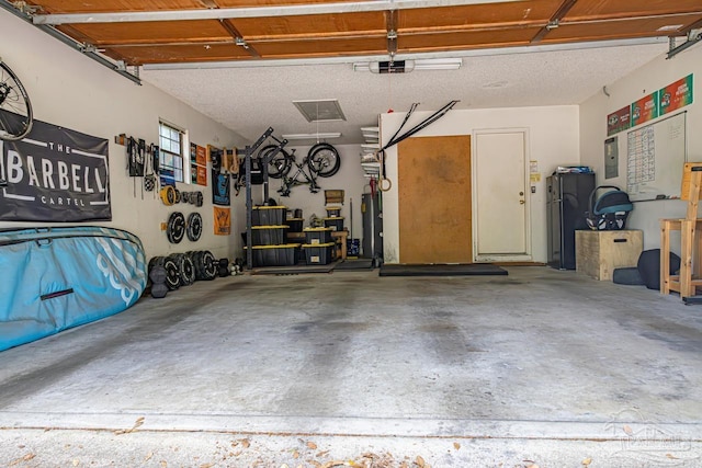 10129 Huntsman Path, Pensacola, FL 32514 - garage with a garage door opener and fridge