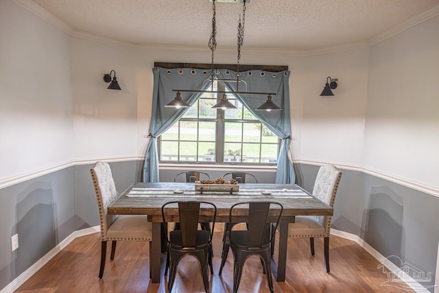 10129 Huntsman Path, Pensacola, FL 32514 - dining room featuring crown molding, a textured ceiling, wainscoting, and wood finished floors