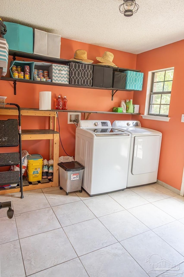 10129 Huntsman Path, Pensacola, FL 32514 - laundry room featuring tile patterned floors, laundry area, a textured ceiling, and washing machine and clothes dryer