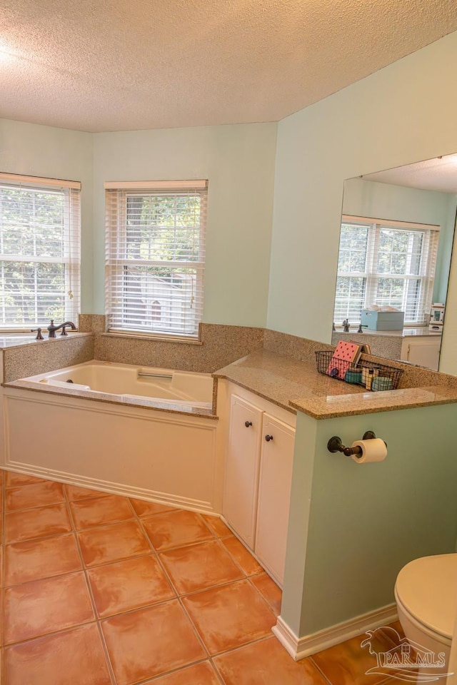 10129 Huntsman Path, Pensacola, FL 32514 - bathroom with a garden tub, tile patterned floors, a wealth of natural light, and toilet