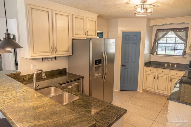 10129 Huntsman Path, Pensacola, FL 32514 - kitchen featuring a sink, stainless steel appliances, a textured ceiling, and cream cabinetry