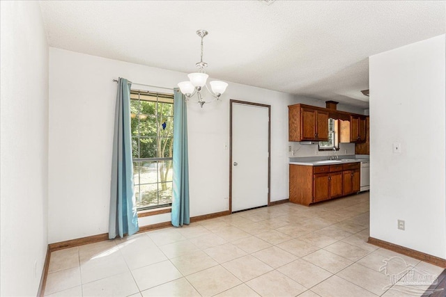 5471 Shamrock St, Milton, FL 32570 - kitchen with a chandelier, light countertops, brown cabinets, white dishwasher, and a sink