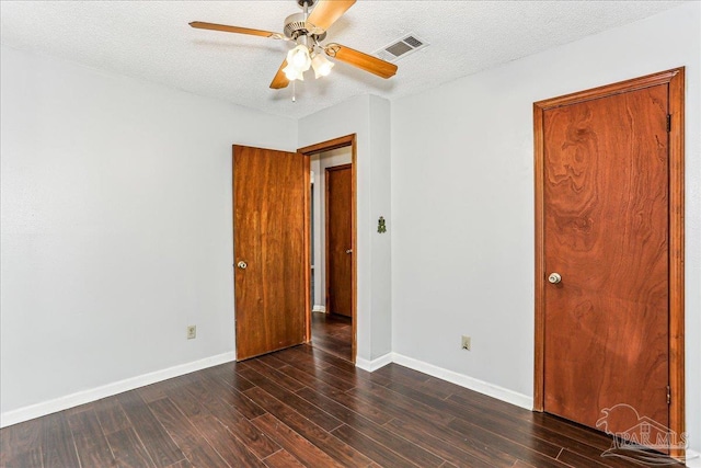 5471 Shamrock St, Milton, FL 32570 - unfurnished room featuring dark wood-type flooring, a ceiling fan, baseboards, and a textured ceiling