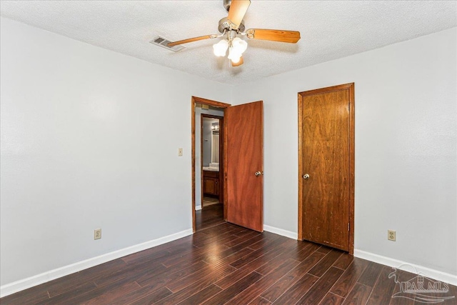 5471 Shamrock St, Milton, FL 32570 - unfurnished bedroom featuring wood finished floors, baseboards, ceiling fan, and a textured ceiling