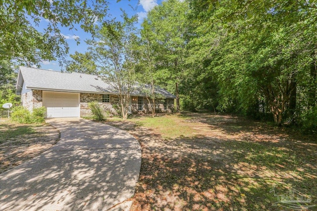 5471 Shamrock St, Milton, FL 32570 - view of front of property with concrete driveway, brick siding, a garage, and roof with shingles