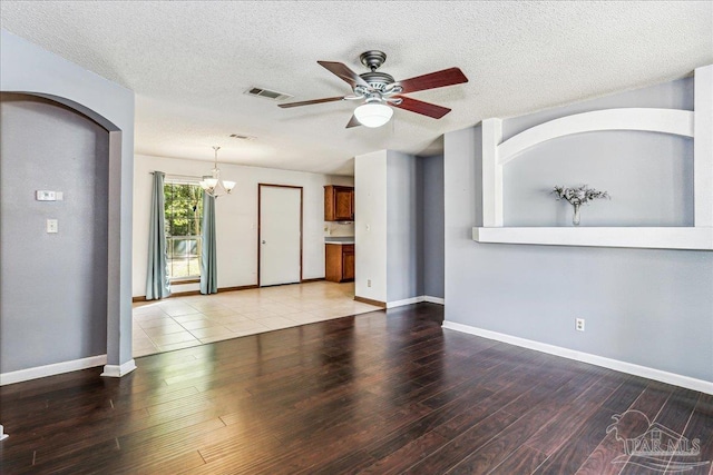 5471 Shamrock St, Milton, FL 32570 - unfurnished living room featuring wood finished floors, a ceiling fan, a chandelier, a textured ceiling, and baseboards