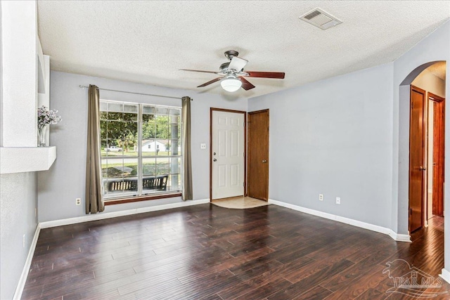 5471 Shamrock St, Milton, FL 32570 - spare room with arched walkways, a ceiling fan, wood finished floors, a textured ceiling, and baseboards