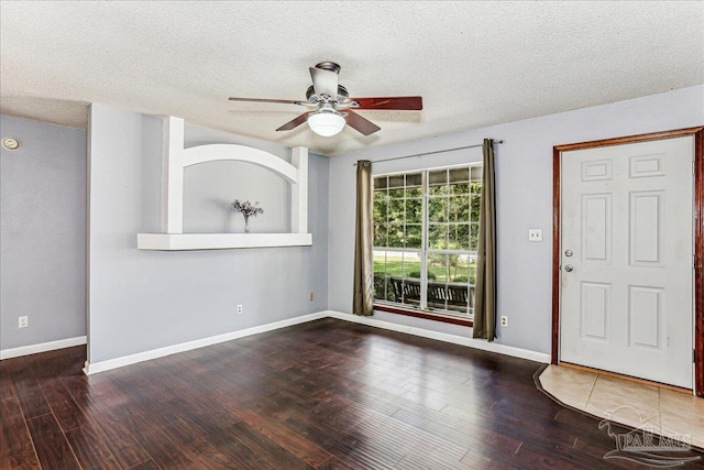 5471 Shamrock St, Milton, FL 32570 - foyer featuring a ceiling fan, wood finished floors, a textured ceiling, and baseboards