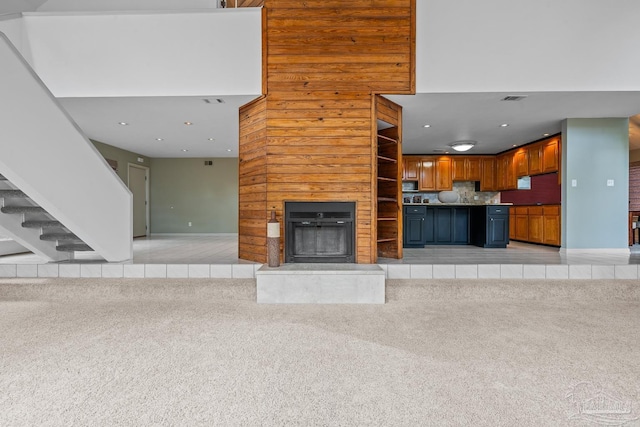 1567 Whisper Bay Blvd, Gulf Breeze, FL 32563 - unfurnished living room with a fireplace with raised hearth, light carpet, stairs, baseboards, and recessed lighting