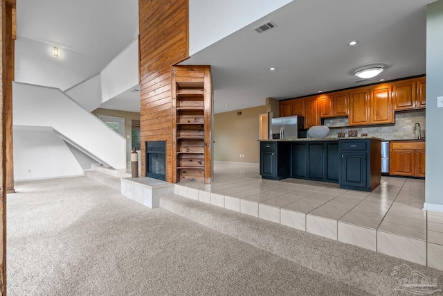 1567 Whisper Bay Blvd, Gulf Breeze, FL 32563 - kitchen with stainless steel fridge with ice dispenser, open floor plan, black microwave, a fireplace, and a sink