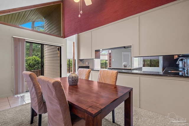 1567 Whisper Bay Blvd, Gulf Breeze, FL 32563 - dining space with light tile patterned floors, light carpet, and a towering ceiling