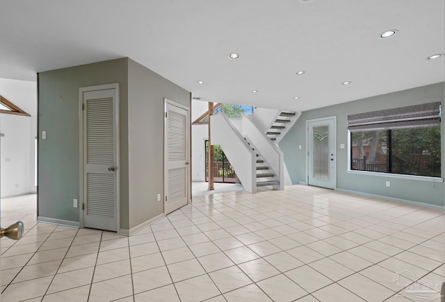 1567 Whisper Bay Blvd, Gulf Breeze, FL 32563 - unfurnished living room with stairs, recessed lighting, light tile patterned floors, and baseboards
