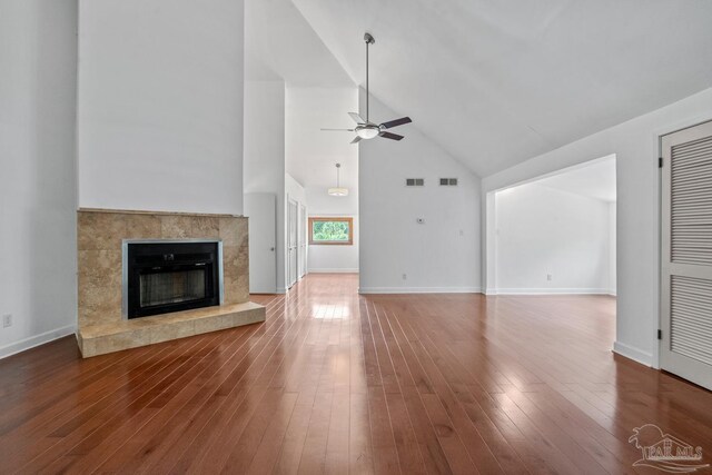 1567 Whisper Bay Blvd, Gulf Breeze, FL 32563 - unfurnished living room with high vaulted ceiling, ceiling fan, a high end fireplace, wood finished floors, and baseboards