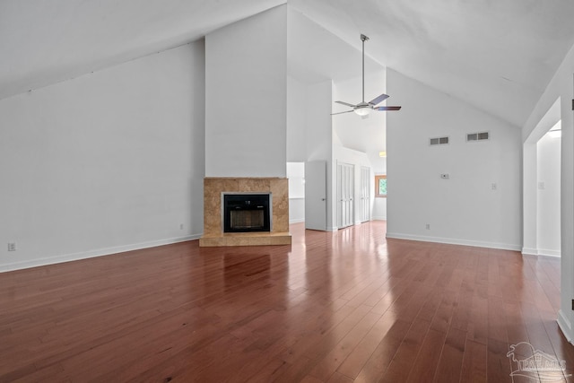 1567 Whisper Bay Blvd, Gulf Breeze, FL 32563 - unfurnished living room featuring wood finished floors, ceiling fan, a tile fireplace, high vaulted ceiling, and baseboards