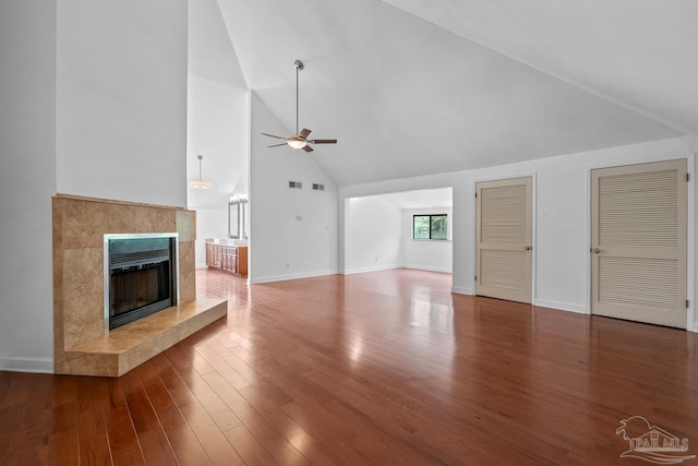 1567 Whisper Bay Blvd, Gulf Breeze, FL 32563 - unfurnished living room with ceiling fan, high vaulted ceiling, a fireplace, wood finished floors, and baseboards