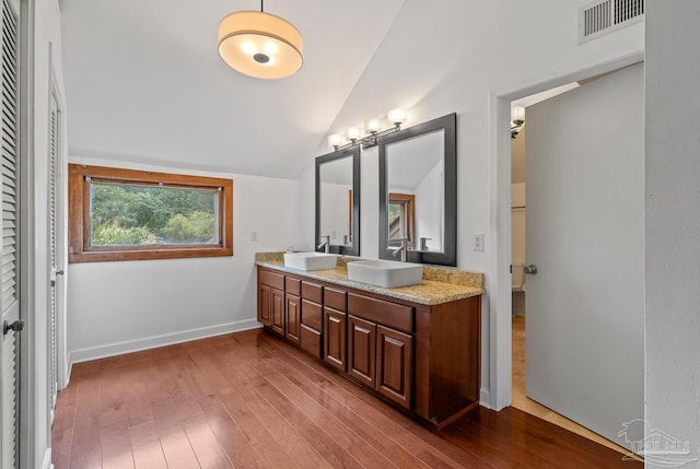 1567 Whisper Bay Blvd, Gulf Breeze, FL 32563 - full bathroom featuring double vanity, wood finished floors, vaulted ceiling, and baseboards