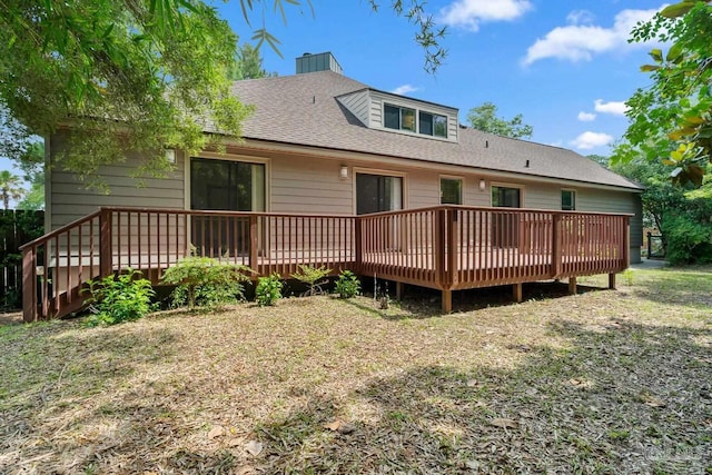 1567 Whisper Bay Blvd, Gulf Breeze, FL 32563 - back of house with roof with shingles, a deck, and a chimney