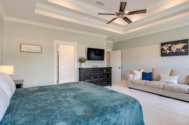 carpeted bedroom with visible vents, ornamental molding, a raised ceiling, and ceiling fan