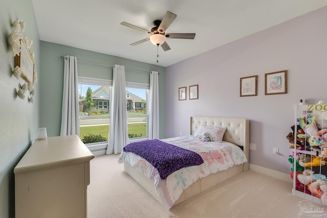 bedroom with baseboards, a ceiling fan, and light colored carpet