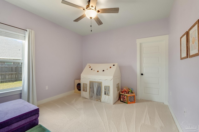 bedroom featuring baseboards, ceiling fan, and carpet