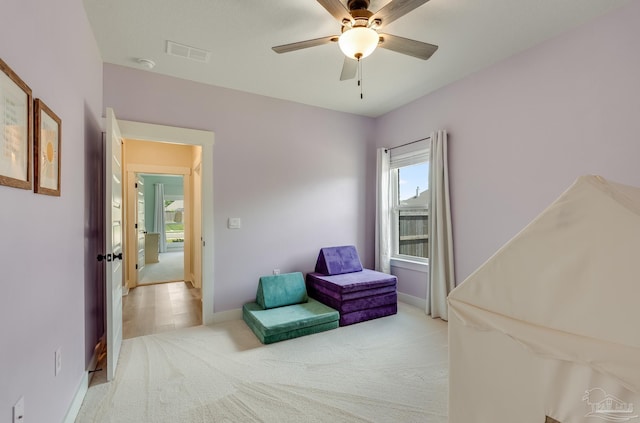 unfurnished room with baseboards, a ceiling fan, carpet flooring, and visible vents