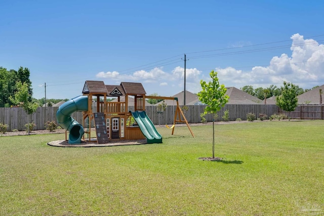 view of play area featuring a lawn and a fenced backyard