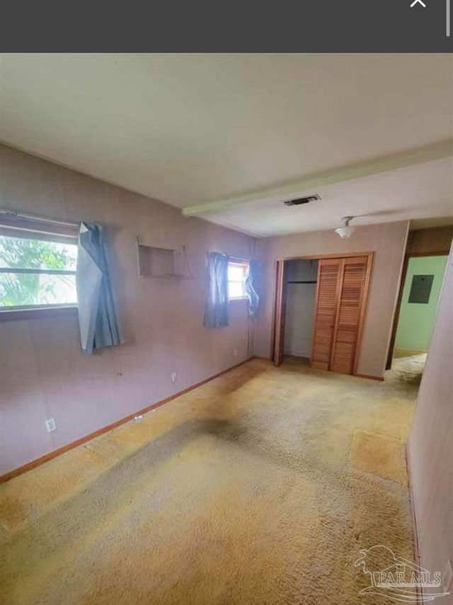 unfurnished bedroom with light carpet, visible vents, and baseboards