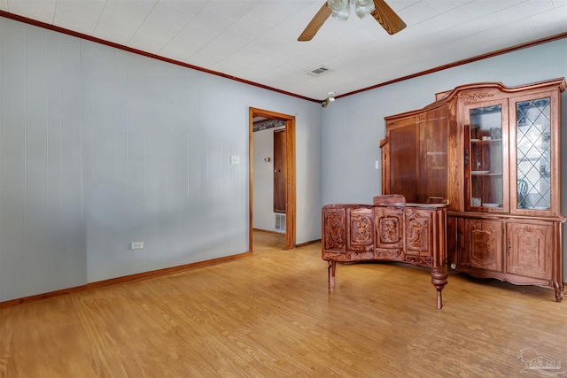 unfurnished bedroom with light wood finished floors, visible vents, and crown molding