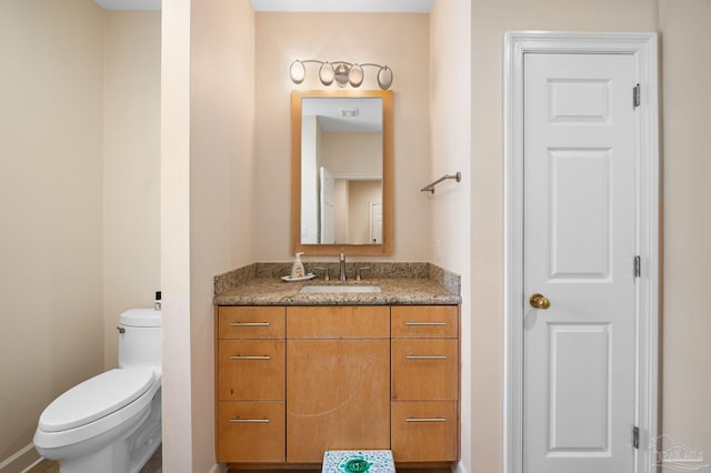 bathroom featuring vanity and toilet