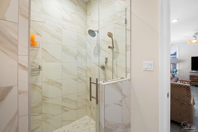 bathroom with a shower with door and ceiling fan