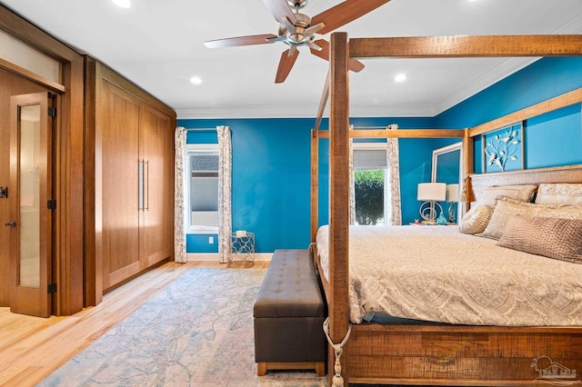 bedroom with ceiling fan, light wood-type flooring, and crown molding