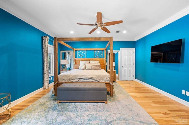 bedroom with ornamental molding, hardwood / wood-style floors, and ceiling fan