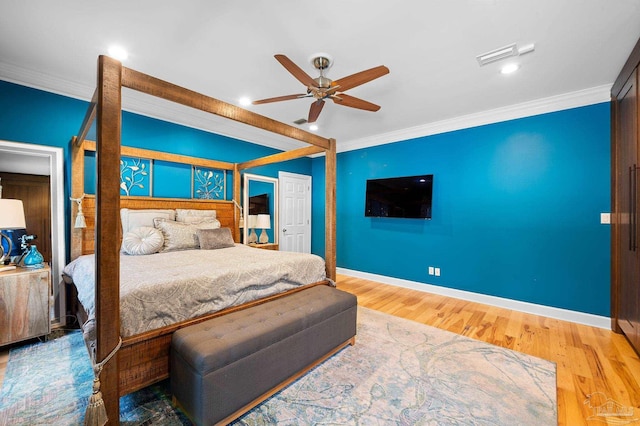 bedroom featuring wood-type flooring, crown molding, and ceiling fan